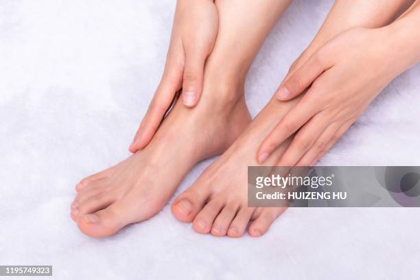 perfect female feet. hand touching - human limb stock pictures, royalty-free photos & images
