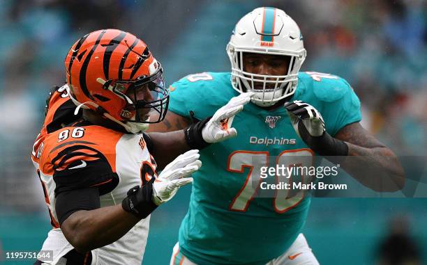 Carlos Dunlap of the Cincinnati Bengals rushes the passer against Julie'n Davenport of the Miami Dolphins in the first quarter at Hard Rock Stadium...