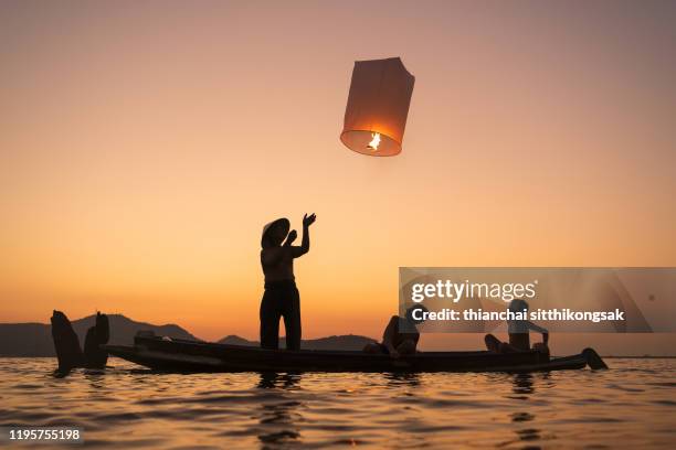 floating asian lanterns for lucky to family - festival of flight at biggin hill airport stockfoto's en -beelden