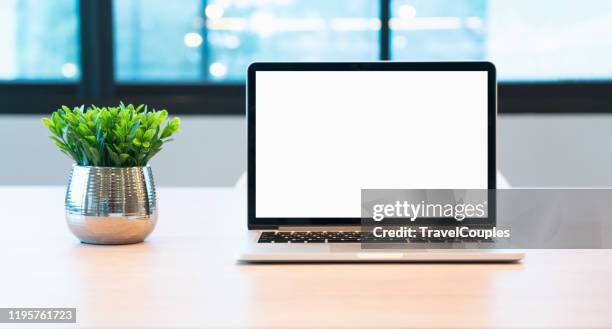 laptop computer blank screen on table in cafe background. laptop with blank screen on table of coffee shop blur background. - coffee table front view stock pictures, royalty-free photos & images