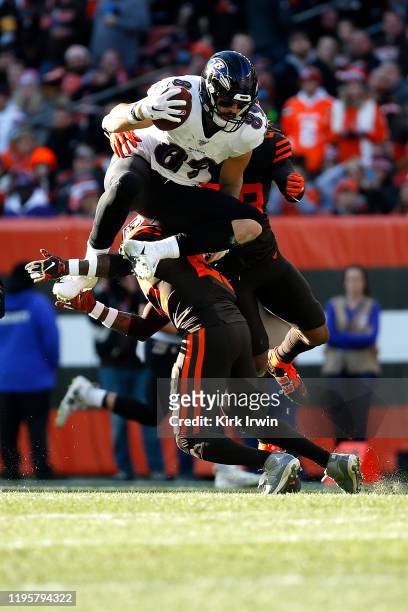 Mark Andrews of the Baltimore Ravens jumps over Damarious Randall of the Cleveland Browns during the game at FirstEnergy Stadium on December 22, 2019...