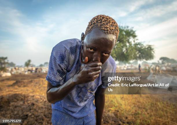 Mundari tribe boy showering with cow urine to take advantage of the antibacterial properties, Central Equatoria, Terekeka, South Sudan on November...