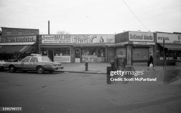 View, from Veteran's Square park , of various local businesses along 102nd Street, in the Corona neighborhood of Queens, New York, New York, April...