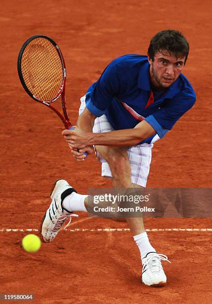 Gilles Simon of France returns a backhand during his quarter final match against Gael Monfils of France during the bet-at-home German Open Tennis...