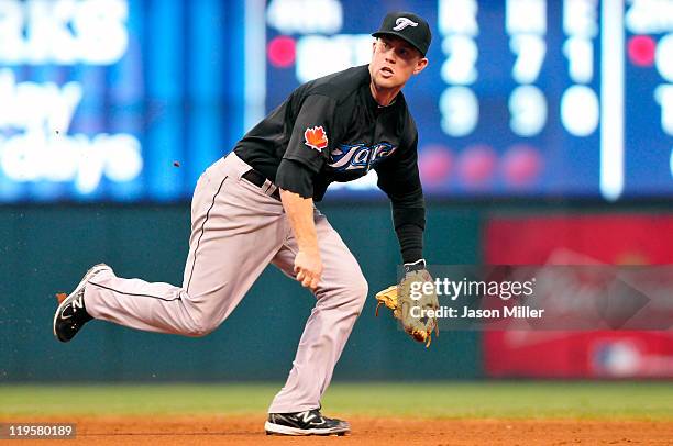 Second baseman Aaron Hill of the Toronto Blue Jays runs to catch a ground ball from Carlos Santana during the sixth inning of the Cleveland Indians...