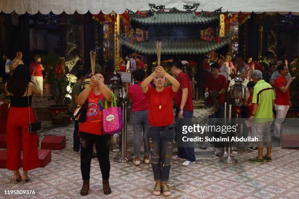 Worshippers pray at the Thian Hock Keng temple on January 24, 2020 in Singapore. On January 25, people around the world will welcome the Year of the...