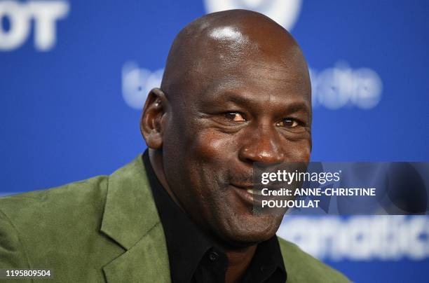Former NBA star and owner of Charlotte Hornets team Michael Jordan looks on as he addresses a press conference ahead of the NBA basketball match...