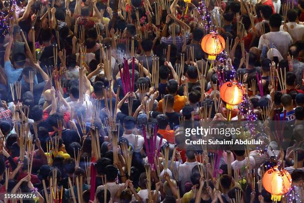Worshippers gather to offer incense to the Goddess of Mercy at the Kwan Im Thong Hood Cho Temple on Lunar New Year on January 25, 2020 in Singapore....