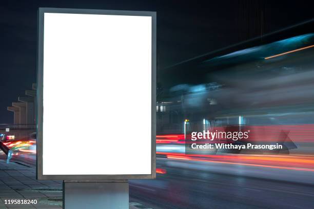 blank billboard on the highway during the twilight with city background with clipping path on screen.- can be used for display your products or promotional - billboard night stock pictures, royalty-free photos & images