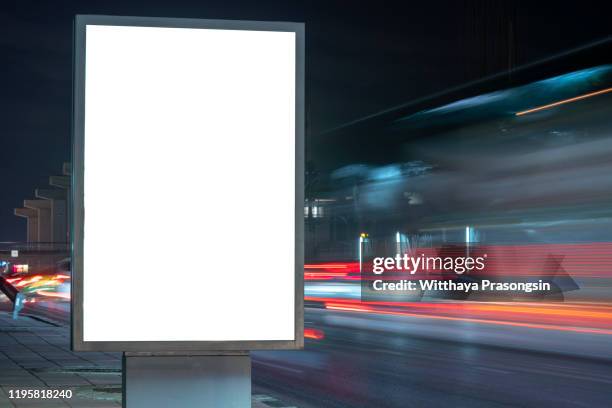 blank billboard on the highway during the twilight with city background with clipping path on screen.- can be used for display your products or promotional - road sign board 個照片及圖片檔