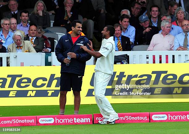 India bowler Praveen Kumar shares a joke with injured bowler Zaheer Khan during day two of the 1st npower test match between England and India at...