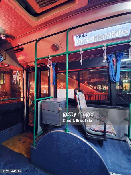 inside view of empty bus at night - bus interior stock-fotos und bilder