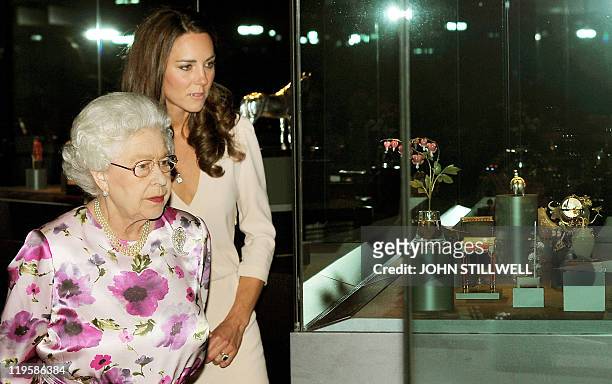 Britain's Queen Elizabeth II and Catherine, the Duchess of Cambridge view a glass cabinet containing part of the Royal Faberge collection at the...