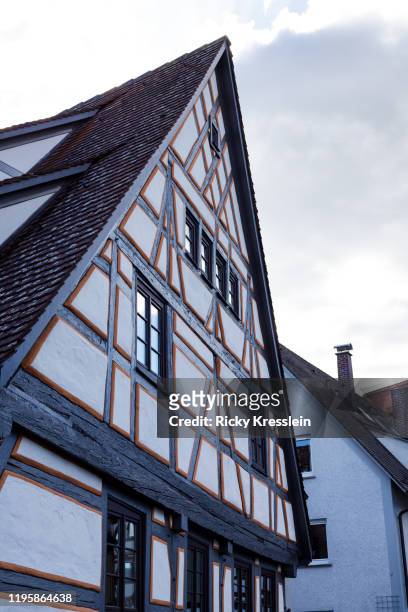 german house roof with painted facade - ricky kresslein stock-fotos und bilder