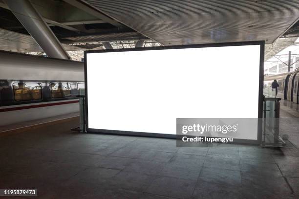 blank billboard at railroad station - städtebaumodell stock-fotos und bilder