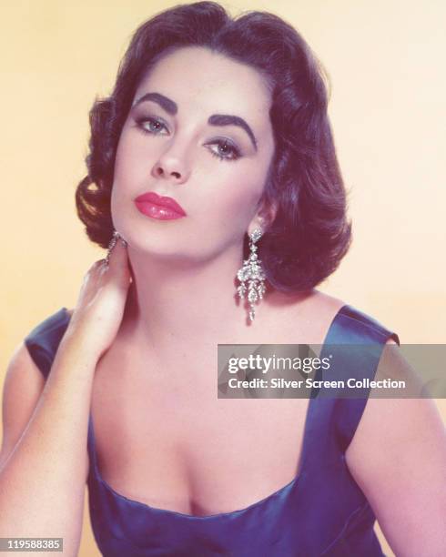 Elizabeth Taylor , British actress, in a studio portrait, against a pale yellow background, circa 1955.