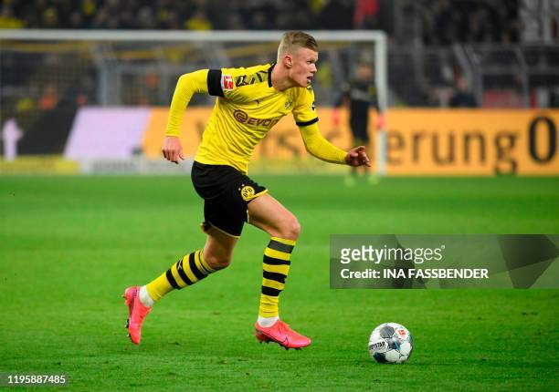 Dortmund's Norwegian forward Erling Braut Haaland runs with the ball during the German first division Bundesliga football match Borussia Dortmund v...