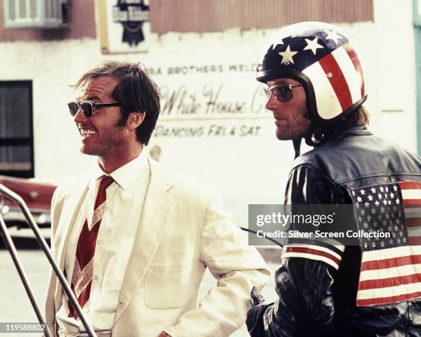 Jack Nicholson and Peter Fonda, wearing a stars-and-stripes helmet and matching leather jacket, in a publicity still issued for the film, 'Easy...