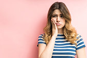 Female Feeling Painful Toothache Against Plain Background