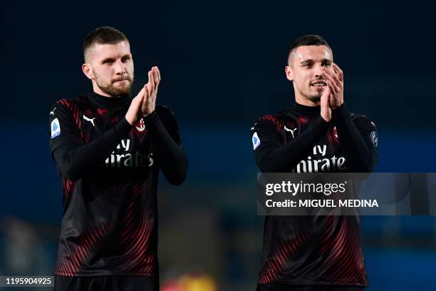 Milan's Croatian forward Ante Rebic and AC Milan's Italian defender Mattia Caldara applaud at the end of the Italian Serie A football match between...