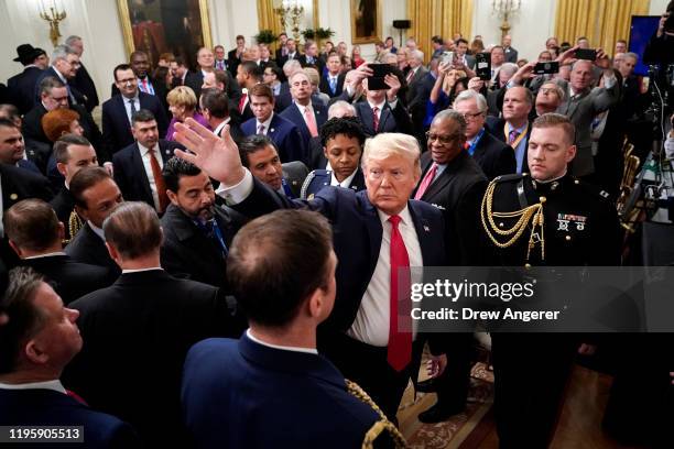 President Donald Trump waves as he exits East Room of the White House following an event with U.S. Mayors on January 24, 2020 in Washington, DC. The...