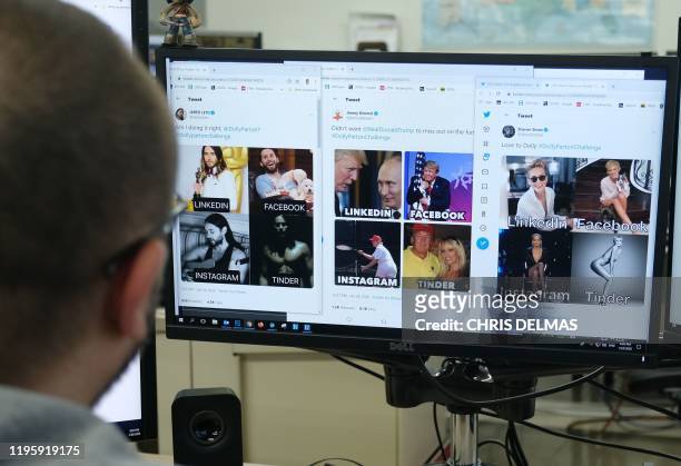 An editor looks at a monitor showing different memes inspired by #DollyPartonChallenge in Los Angeles on January 24, 2020. - Celebrities from Mark...