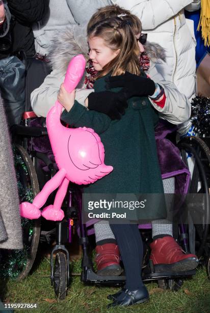 Princess Charlotte of Cambridge is given a hug by a wellwisher as she attends the Christmas Day Church service at Church of St Mary Magdalene on the...