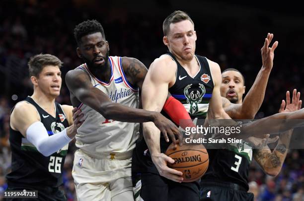 Pat Connaughton of the Milwaukee Bucks jostles James Ennis III of the Philadelphia 76ers for the ball during the second half of the game at Wells...