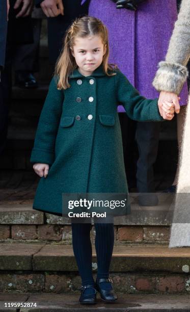 Princess Charlotte of Cambridge is given a hug by a wellwisher as she attends the Christmas Day Church service at Church of St Mary Magdalene on the...