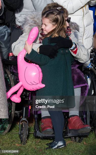 Princess Charlotte of Cambridge is given a hug by a wellwisher as she attends the Christmas Day Church service at Church of St Mary Magdalene on the...