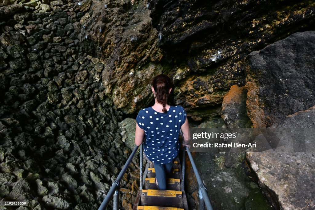 Woman entering an underground cave