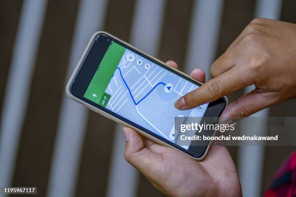 close up of man using  smartphone with a gps map - gps ストックフォトと画像