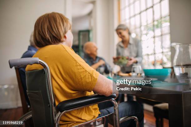 group of seniors sharing food in retirement community - share house stock pictures, royalty-free photos & images