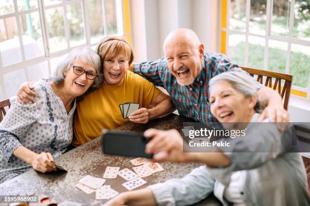 young at heart seniors having fun time in nursing home - poker wallpaper stock pictures, royalty-free photos & images