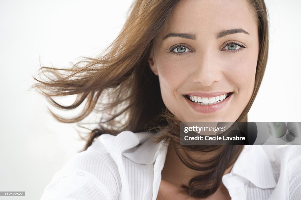 Portrait of a young woman with windblown hair