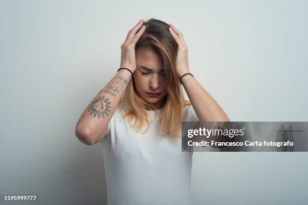 woman with headache - sad tattoos stockfoto's en -beelden