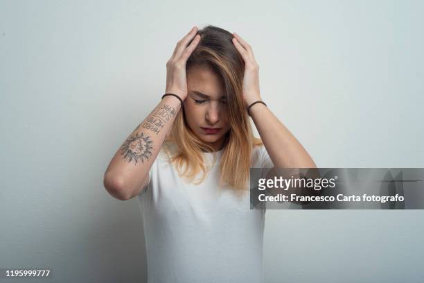 woman with headache - woman head in hands sad stock pictures, royalty-free photos & images