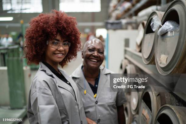 portrait of colleagues working in the factory - working class mother stock pictures, royalty-free photos & images
