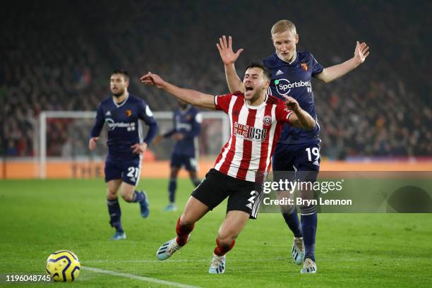 George Baldock of Sheffield United is challenged by Will Hughes of Watford during the Premier League match between Sheffield United and Watford FC at...