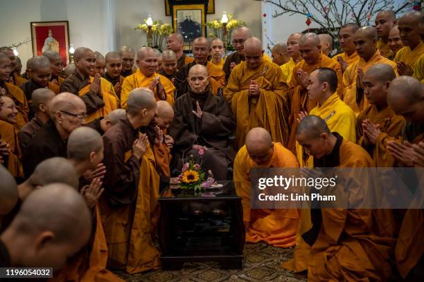 Buddhist monks and nuns greet zen master Thich Nhat Hanh at a praying ceremony marking the first day of Lunar New Year at Tu Hieu temple on January...