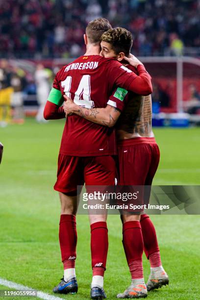 Roberto Firmino of Liverpool celebrates his goal with his teammate Jordan Henderson of Liverpool during the FIFA Club World Cup Final match between...