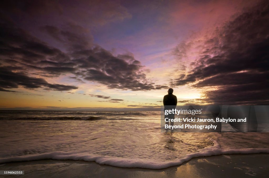 Senior Man Watching the Sunset Sky at Fort Myers Beach, Florida