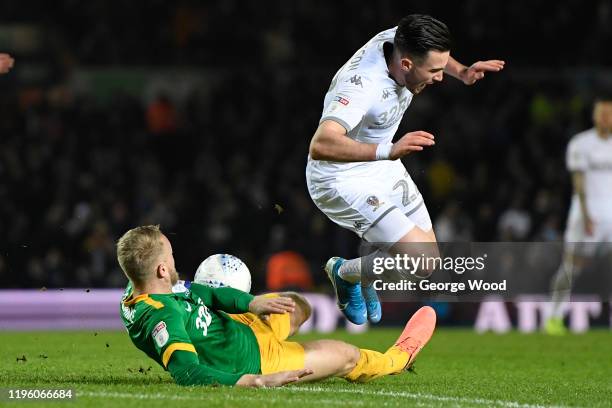 Jack Harrison of Leeds United is tackled by Tom Clarke of Preston North End during the Sky Bet Championship match between Leeds United and Preston...