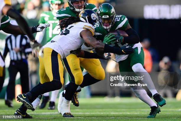 Le'Veon Bell of the New York Jets is tackled by Mark Barron of the Pittsburgh Steelers at MetLife Stadium on December 22, 2019 in East Rutherford,...