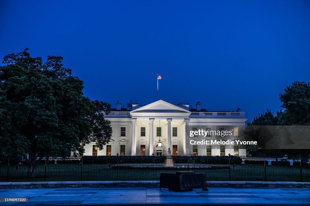 Horizontal color photo of White House in Washington DC on a clear summer evening