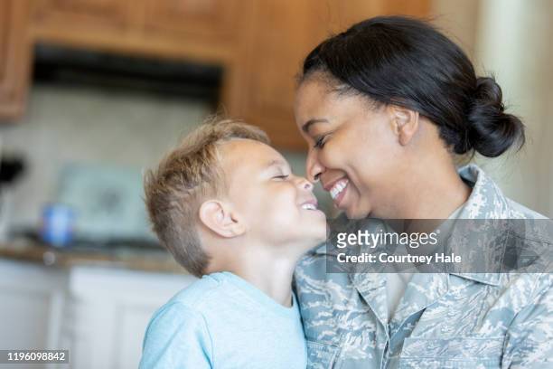 army mom and young son being affectionate - ranking member stock pictures, royalty-free photos & images