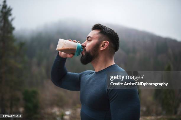 sportsman drinking protein outdoor - protein stock pictures, royalty-free photos & images