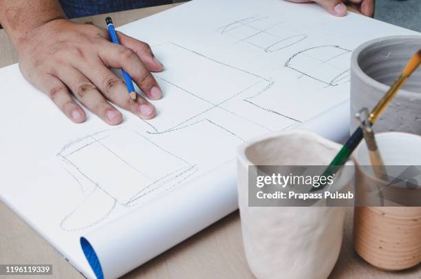 production designer sketching drawing development prototype process design idea creative concept - drawing artistic product - fotografias e filmes do acervo