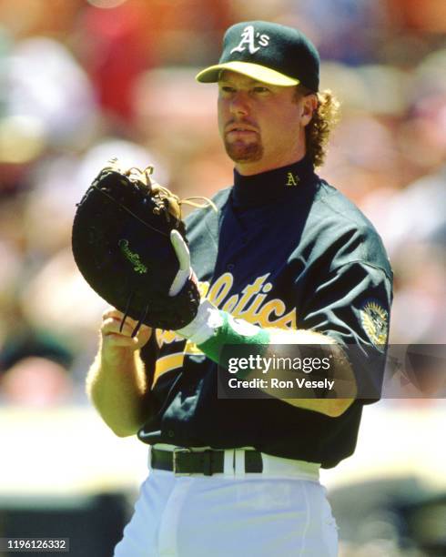 Mark McGwire of the Oakland Athletics bats during an MLB game at the Oakland Coliseum in Oakland, California during the 1996 season.