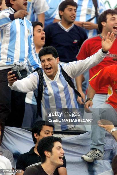 Argentine fans cheer in the National Stadium in Santiago, Chile, during a game between the Chilean and Argentine selections, 15 November 2000....